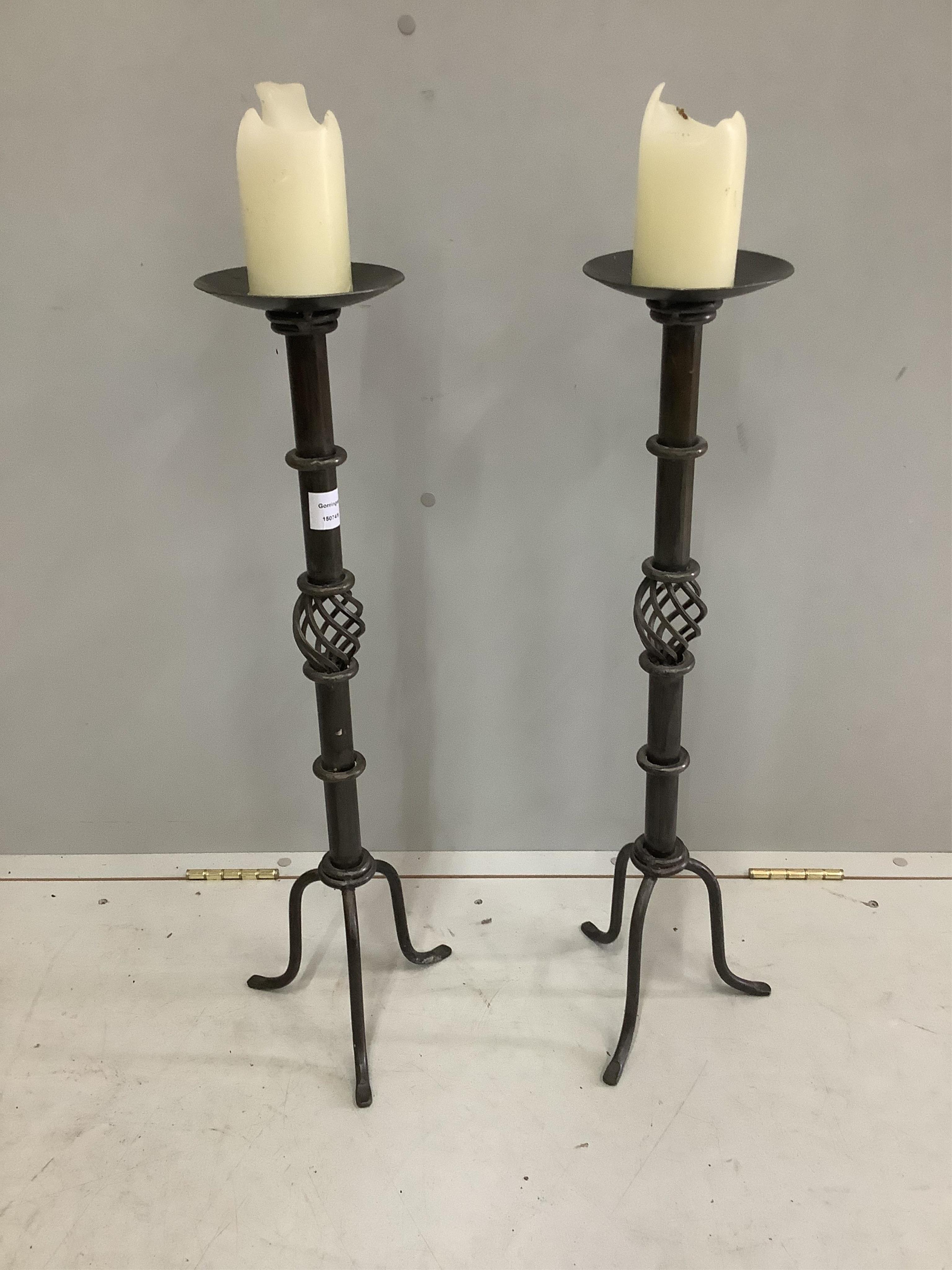 A pair of 18th century style wrought iron pricket candlesticks, height 73cm. Condition - good